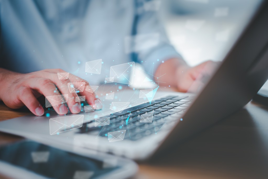 business man working on laptop computer and he is sending email