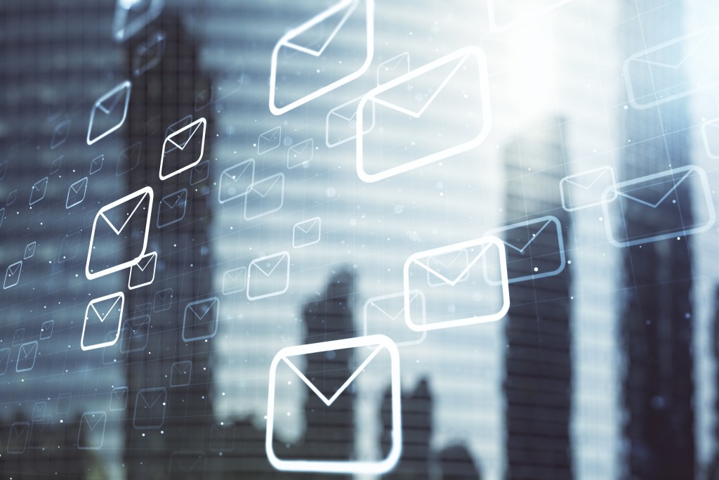 Double exposure of abstract virtual postal envelopes hologram on modern skyscrapers background. Electronic mail and spam concept