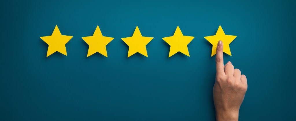 Customer Experience Concept. Woman hand showing on five star excellent rating on background, copy space